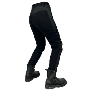 Detail view of motorcycle jeans with gray panels and black biker boots in side profile