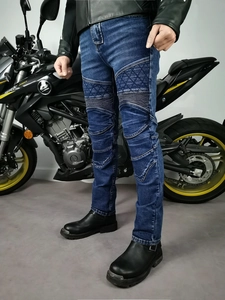 Close-up of flexible accordion panels on knees of motorcycle jeans for riding comfort