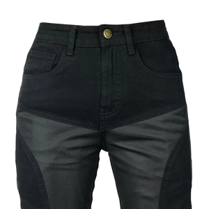 Detail of slim motorcycle jeans with grey mesh panels and a vintage gold button