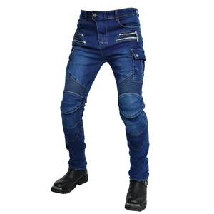 Detailed view of knee accordion stretch panels and metal zippers on biker jeans