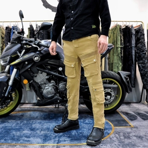 Detail view of khaki motorcycle cargo pants with pleated stretch panels and large side pockets