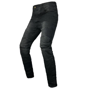 Detail of vintage gray motorcycle jeans featuring pleated stretch panels and faded wash