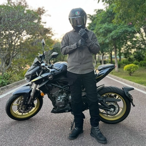Outdoor shot of full motorcycle gear including gray riding jacket and matching pants