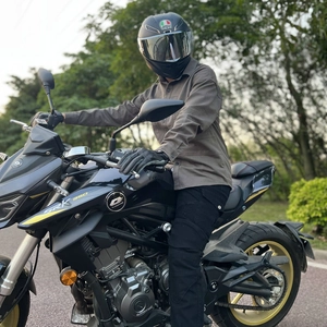 Outdoor motorcycle riding gear detail featuring dark coffee shirt and black cargo pants