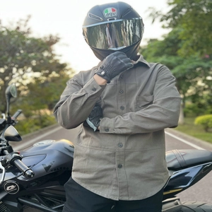 Outdoor shot of a grey-green motorcycle riding shirt with functional chest pockets