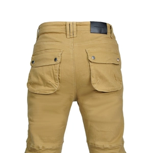 Detail of khaki motorcycle pants featuring cargo back pockets and a leather brand label