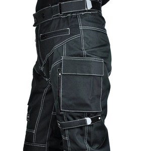 Close-up of tactical motorcycle pants with white contrast stitching and utility pockets