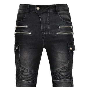 Detail of motorcycle jeans showing metal zippers, ribbed knee panels and cargo pockets