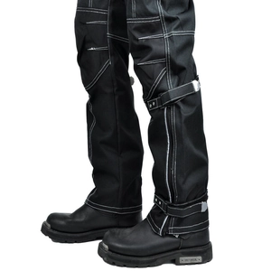 Detail view of motorcycle cargo pants with white contrast stitching and adjustable leg straps