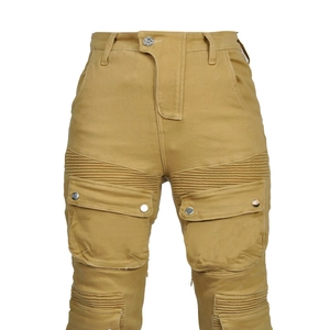Detail view of khaki motorcycle pants featuring flexible accordion panels and cargo pockets