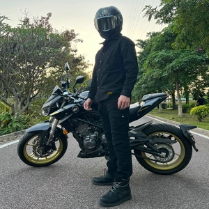 Detailed view of waterproof black motorcycle jacket and protective gear with rider outfit