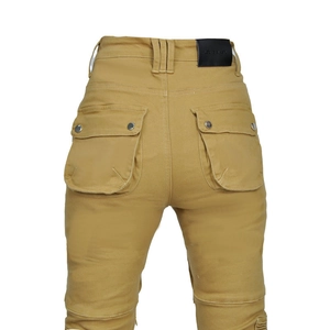 Detail view of khaki biker pants showing flap rear pockets and a leather waist patch