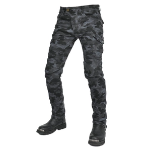 Detail of camouflage motorcycle pants with knee accordion stretch and leather biker boots