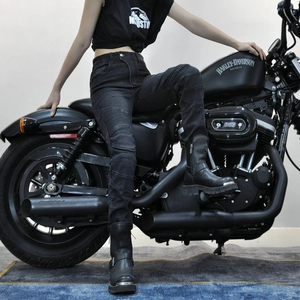 Women's black washed motorcycle jeans with stretch accordion panels on knees in outdoor setting