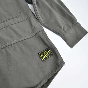 Detail of gray-green motorcycle jacket sleeve featuring the Volero Moto woven brand tag