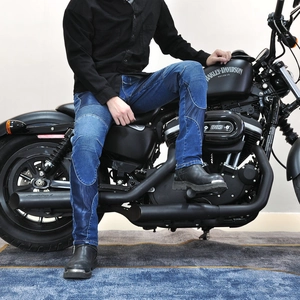 Detail view of denim motorcycle pants featuring accordion stretch panels on the knees