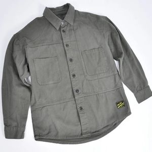 Detail view of olive green motorcycle riding shirt with chest pockets and heavy cotton fabric