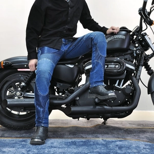 Detail view of reinforced knee padding on vintage blue motorcycle riding jeans