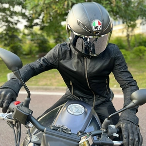 Detail of breathable mesh motorcycle jacket and carbon fiber helmet for racing