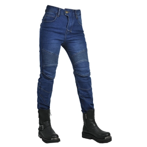 Detail of blue motorcycle jeans with accordion stretch panels at knees and leather boots