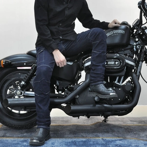 Men's dark blue motorcycle jeans with knee stretch panels shown in a riding position