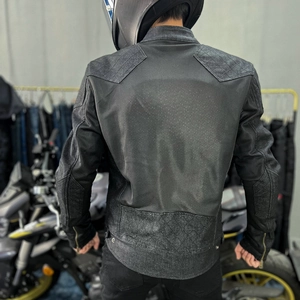 Detail of motorcycle jacket back with breathable mesh panels and quilted protection padding