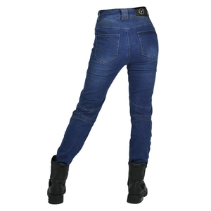Detail of blue motorcycle jeans featuring accordion stretch panels and leather brand patch