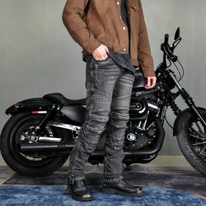 Detail view of motorcycle jeans featuring protective accordion stretch panels at the knee