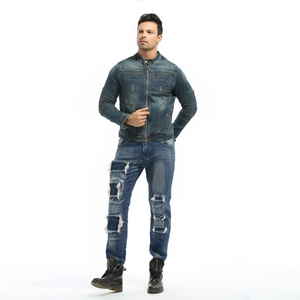 Detail of vintage denim motorcycle jacket and distressed jeans with protective patches