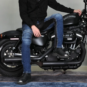 Detail of biker jeans with pleated knee pads shown on a motorcycle rider
