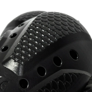 Close-up of black motorcycle armor padding with hexagonal texture and ventilation holes