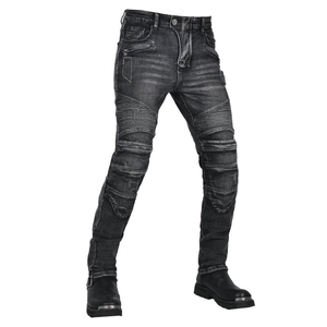Detail of vintage washed motorcycle jeans with accordion stretch panels at the knees
