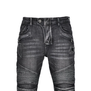 Close-up of vintage washed grey biker jeans featuring ribbed knee panels and metal zippers
