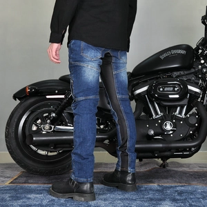 Macro detail of men's slim motorcycle jeans with breathable stretch panels and zip pockets