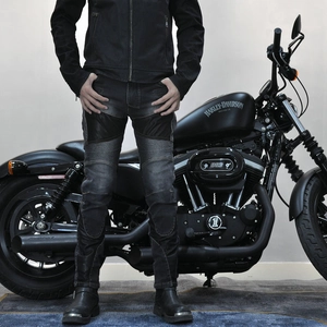 Detail of motorcycle denim jeans with pleated stretch panels on knees for riding comfort