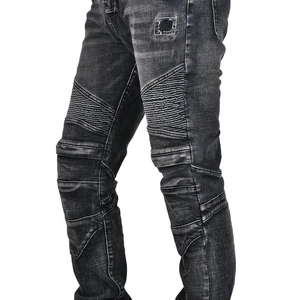 Close-up of vintage grey motorcycle jeans showing protective knee pleats and slim-fit texture