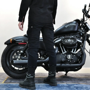 Black motorcycle cargo riding pants with armor padding and Harley-Davidson background