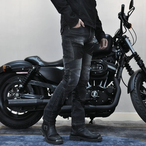 Detail of motorcycle jeans with accordion stretch panels on the knee and washed denim finish