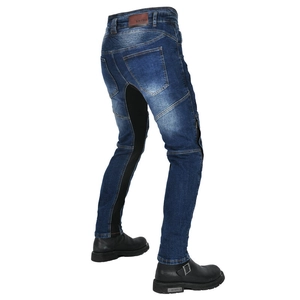 Close-up of motorcycle jeans featuring elastic ribbed panels and brand leather logo