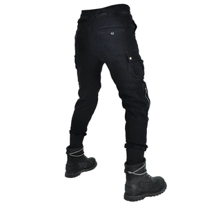 Detailed side view of black cargo motorcycle pants with utility pockets and ankle cuffs