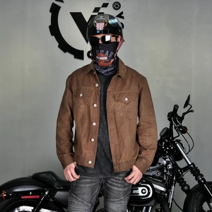 Close-up of waxed canvas motorcycle jacket with metal buttons and chest pockets