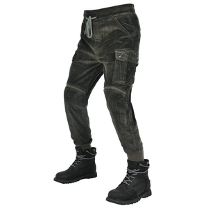 Detail view of dark green corduroy cargo motorcycle pants paired with black work boots