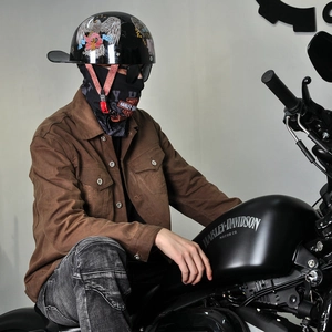 Detail of retro motorcycle jacket sleeve with a helmet featuring eagle and flag graphics