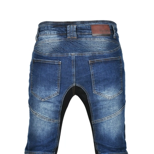 Detail of motorcycle jeans featuring stretch accordion panels and leather brand patch