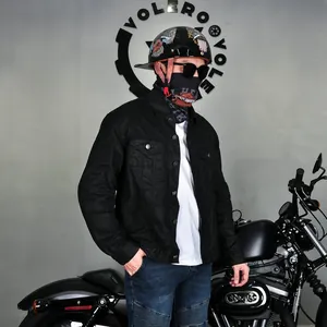 Close-up of a retro waxed motorcycle jacket with protective gear in industrial setting