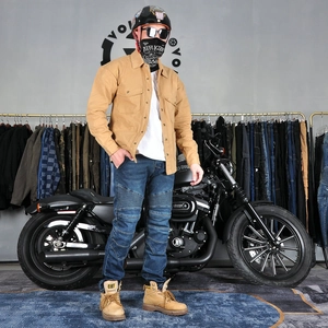 Men's vintage motorcycle riding jacket and protective jeans with a heavy cruiser bike