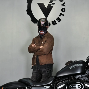 Detail of vintage brown waxed canvas motorcycle jacket with industrial collar and pockets