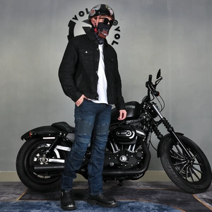 Detail of blue motorcycle riding jeans featuring accordion stretch panels and knee protection