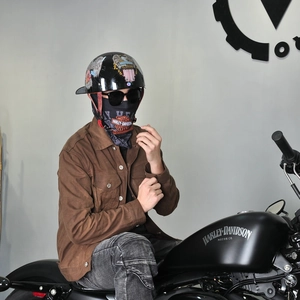 Retro motorcycle riding gear featuring a black eagle-print half helmet and brand neck gaiter