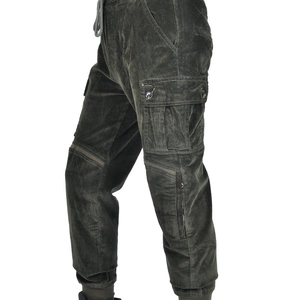 Detail view of military green corduroy motorcycle pants featuring large cargo side pockets